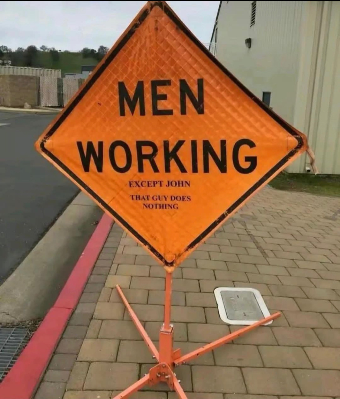 [Picture of Men Working except John sign]